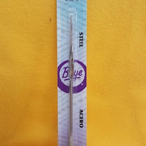 May include: A silver knitting needle with a blue and white label. The label says "Wrights", "2.10MM", "US: 3", "STEEL", "ACERO", "ACIER", and "362083".