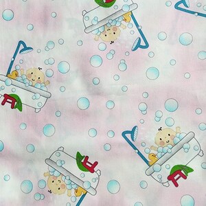 May include: Fabric with a repeating pattern of babies in bathtubs with bubbles and shower heads. The babies are in white bathtubs with red and green accents. The background is a light pink with blue bubbles.