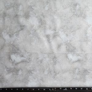 Shades of grey gray storm clouds background blender with tiny silver metallic highlights. quilting fabric 100% cotton.   Priced by 1/2 yard.