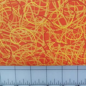 May include: Orange and yellow fabric with a swirling pattern. The fabric is textured and has a woven look.