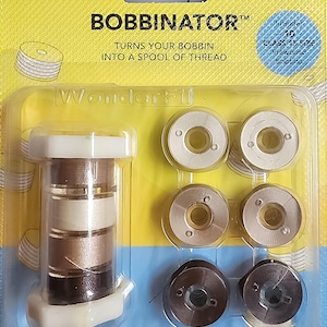 May include: A package of WonderFil Bobbinator specialty threads. The package includes a bobbin winder and several spools of thread in various shades of brown and beige. The text on the package reads "BOBBINATOR" and "TURNS YOUR BOBBIN INTO A SPOOL OF THREAD."