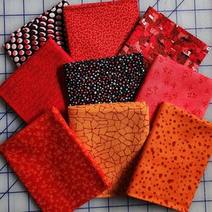 100% cotton fabric fat 1/4 quarter pack bundle. Red orange 9 FQ&#39;s. Total 2.25 yards.