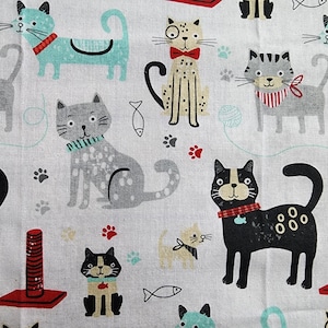 May include: A white fabric with a repeating pattern of colorful cats. The cats are in various poses, including sitting, standing, and lying down. Some cats have red collars, while others have green collars. There are also small fish and paw prints scattered throughout the fabric.