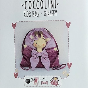 May include: A Stafil Coccolini Kids Bag - Giraffy DIY craft kit package featuring a purple drawstring bag with a plush giraffe head, a lavender bow, and a small matching hair bow. The packaging includes icons for cutting, sewing, and assembly.