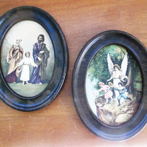 Lithographs in metal oval frames of The Holy Family and Guardian Angel with children in antique condition and ready to hang.