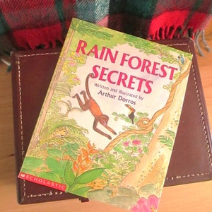 Rain Forest Secrets book published 1990, a good read for older kids with colorful illustrations in gift giving condition