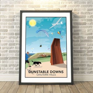 May include: A colourful illustration of Dunstable Downs, a popular spot for paragliding and hang gliding in the Chiltern Hills. The image features a blue sky with white clouds, a sun, a paraglider, a hang glider, a person walking a dog, and a person riding a horse. The text "Dunstable Downs Chiltern Hills" is at the bottom of the image.