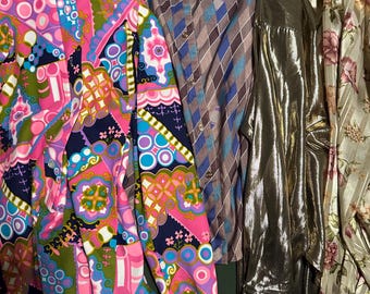 May include: A collection of vintage button-down shirts in various patterns and colors. The shirts include a vibrant pink, purple, and green patterned shirt, a brown and blue diamond-patterned shirt, a gold metallic shirt, and a floral print shirt.