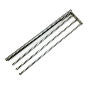 May include: A chrome-finished towel rack with three parallel bars and a rectangular top section. The bars have rounded ends. The rack is designed to hold towels and is made of a shiny, metallic material.