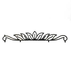 May include: A black metal decorative wall accent featuring a symmetrical, elongated horizontal design with stylized leaf-like cutouts and curved scrollwork ends. The piece includes small mounting tabs along the bottom edge for installation.