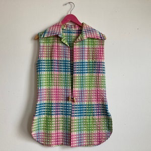 May include: A sleeveless vest with a collar in a plaid pattern of pink, green, blue, and white.