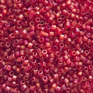 May include: A close-up image of a large quantity of small, red, iridescent glass beads. The beads are round and have a slightly irregular shape. They are perfect for jewelry making or other craft projects.