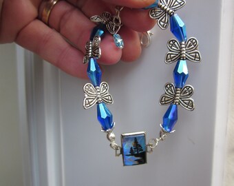 BUTTERFLY WINGS repurposed bracelet w. deep blue/violet swarovski CRYSTAL bead & silver butterfly spacers