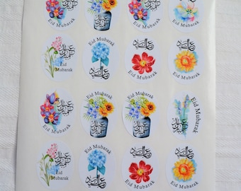 May include: A sheet of 16 round stickers with floral designs and Arabic calligraphy. The stickers say "Eid Mubarak" in English and Arabic. The flowers are in shades of pink, blue, yellow, and red.
