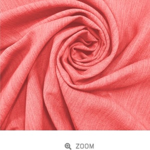 May include: Close-up of a coral-colored slub viscose fabric, showing its soft, textured surface and the way it drapes.