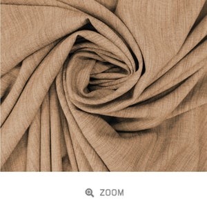 May include: Close-up of a soft, brown fabric with a slub texture. The fabric is called "Slub Viscose - BISCUIT".