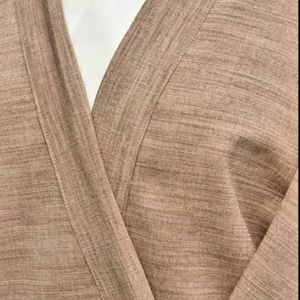 May include: A brown, textured, long-sleeved robe with a white collar. The robe is open in the front, revealing the white collar underneath.