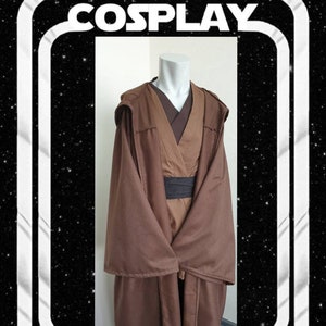 May include: A brown cosplay costume with a hood and long sleeves, displayed on a mannequin. The costume includes a brown robe, a dark brown undershirt, and a black belt. The image has the text "KENICKYS COSPLAY" in a white retro-style frame.