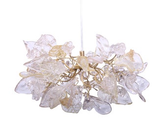 May include: A gold metal chandelier with clear glass flower-shaped shades.
