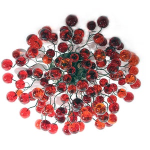 May include: A red and orange glass chandelier with many small round bulbs hanging from a central point.
