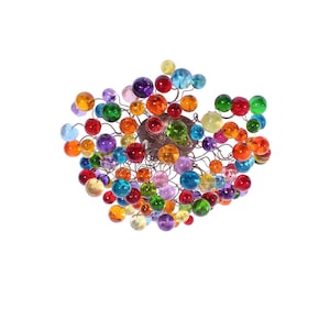 May include: A vibrant chandelier with multiple glass spheres in a range of colours, such as red, orange, yellow, green, blue, and purple. The spheres are connected to a central, brown-toned fitting with thin, dark wires.