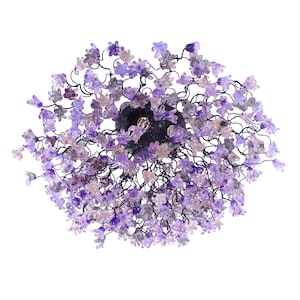 May include: A purple glass chandelier with a floral design. The chandelier is made of many small, delicate flowers that are clustered together. The flowers are a light purple color and have a slightly iridescent finish.
