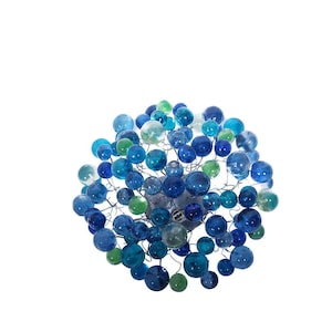 May include: A spherical light fixture featuring a central metal base with numerous thin, radiating wire branches. Each branch is tipped with a translucent glass sphere in various shades of blue, teal, and green, creating a dense, clustered orb.