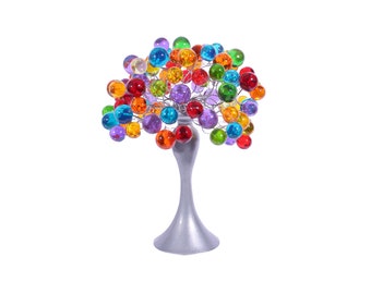 May include: A silver metal tree sculpture with a round base and a canopy of colorful glass orbs. The orbs are in shades of red, orange, yellow, green, blue, purple, and clear.