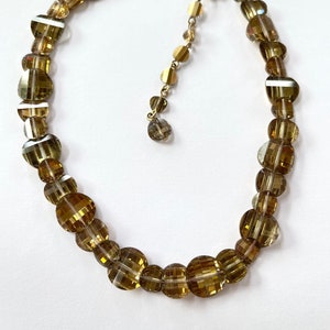 This is a wonderful vintage glass bead necklace with honey checkerboard crystals   Multifaceted 1/2"  and 3/8" oval domed beads.  16".  Bright and sparkling!   Wonderful vintage condition.