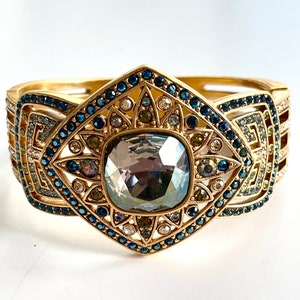 vintage Judith Lieber art deco clamper bracelet with sparkling faceted smoky quartz center stone with blue, clear, green and yellow swarovski crystal stones.    The bracelet is a magnetic clamper and is 7" x 2" i