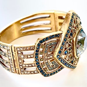 vintage Judith Lieber art deco clamper bracelet with sparkling faceted smoky quartz center stone with blue, clear, green and yellow swarovski crystal stones.    The bracelet is a magnetic clamper and is 7" x 2" i