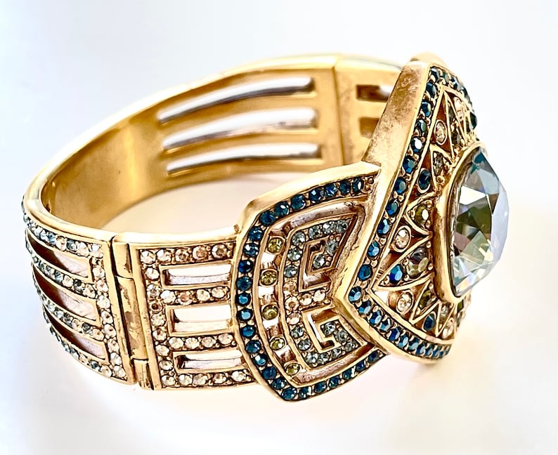 vintage Judith Lieber art deco clamper bracelet with sparkling faceted smoky quartz center stone with blue, clear, green and yellow swarovski crystal stones.    The bracelet is a magnetic clamper and is 7" x 2" i