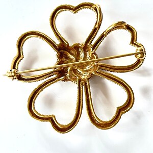 his is a lovely vintage flower brooch with Celtic lovers knot heart flower petals from the Metropolitan Museum collection.  Signed MMA.  2".   Wonderful vintage condition.