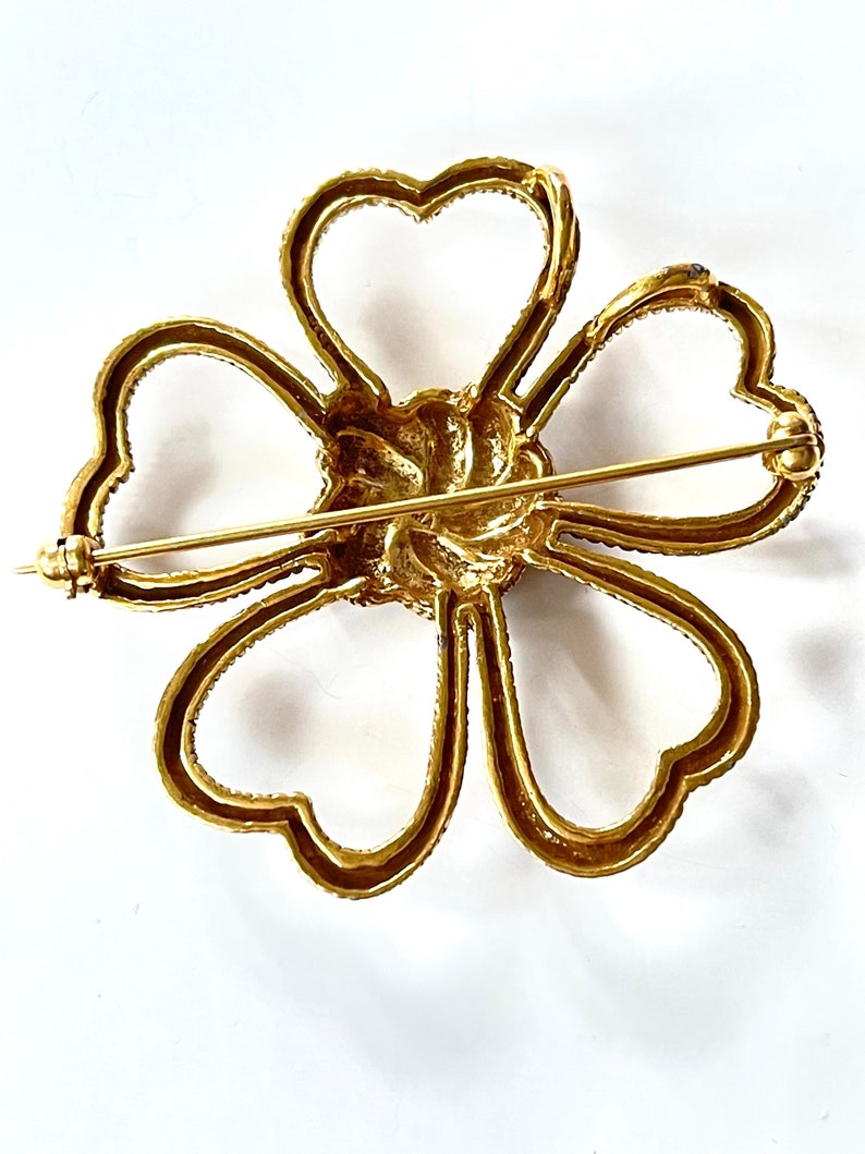 his is a lovely vintage flower brooch with Celtic lovers knot heart flower petals from the Metropolitan Museum collection.  Signed MMA.  2".   Wonderful vintage condition.