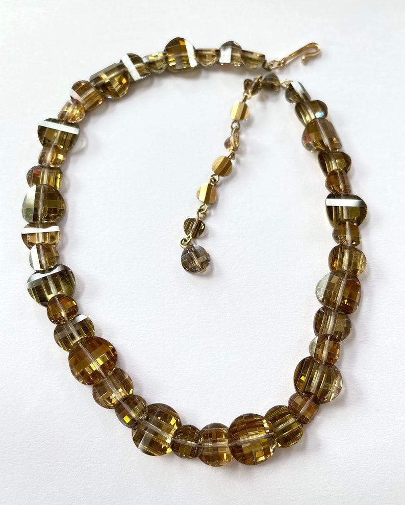 This is a wonderful vintage glass bead necklace with honey checkerboard crystals   Multifaceted 1/2"  and 3/8" oval domed beads.  16".  Bright and sparkling!   Wonderful vintage condition.