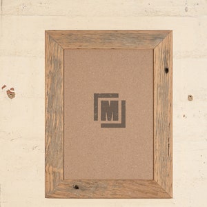 May include: A rustic wooden picture frame with a light brown finish. The frame has a simple design with a slightly distressed look. The frame is empty and ready to display a photo or artwork.