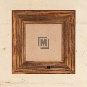 May include: A rustic wooden picture frame with a dark brown finish. The frame has a simple design with a slightly raised edge around the opening. The frame is empty and ready to display a photo or artwork.