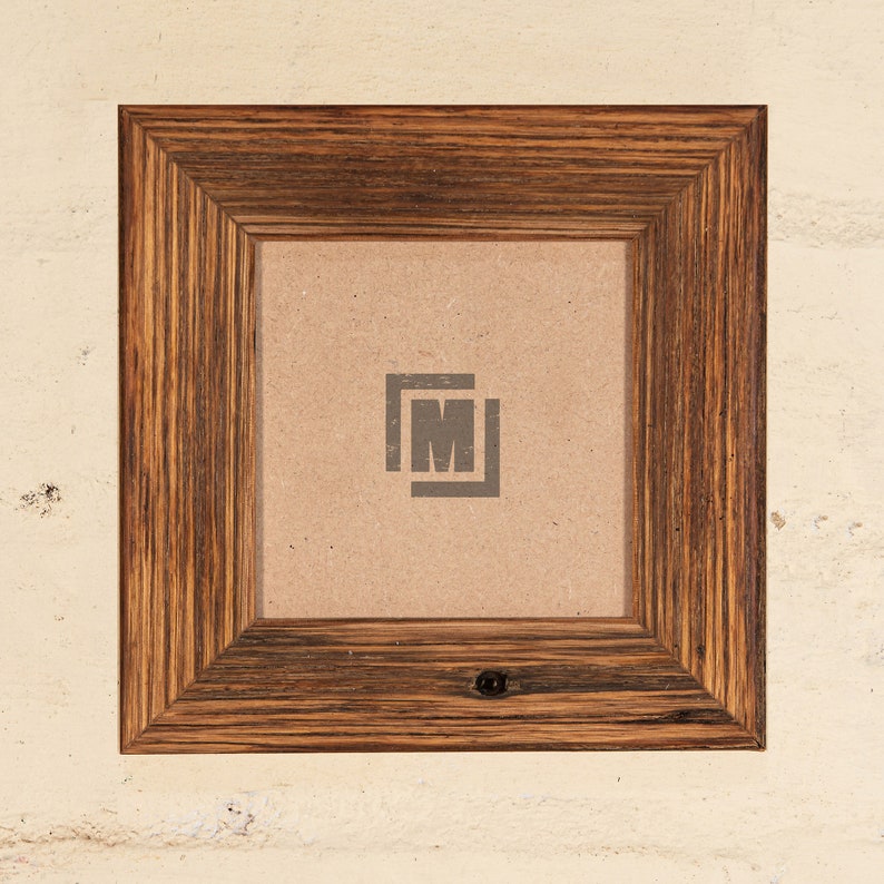 May include: A rustic wooden picture frame with a dark brown finish. The frame has a simple design with a slightly raised edge around the opening. The frame is empty and ready to display a photo or artwork.