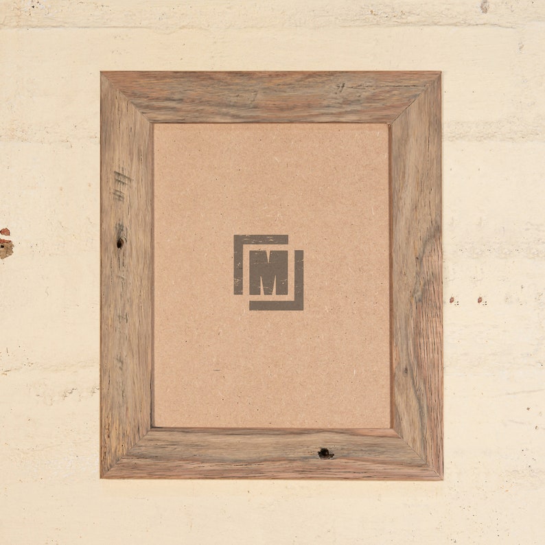 May include: A rustic wood picture frame with a light brown wood finish. The frame has a simple design with a slightly raised edge. The frame is empty and ready to display a photo or artwork.