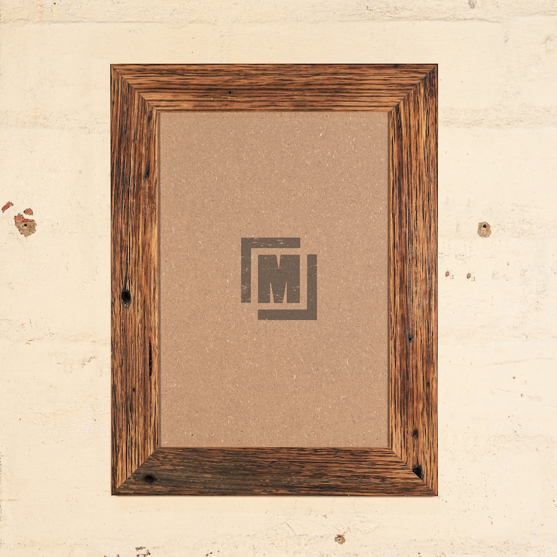 May include: A rustic wooden picture frame with a brown cardboard backing. The frame has a dark brown stain and a visible wood grain. The frame is empty and ready for a picture.