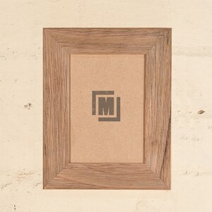May include: A rustic wooden picture frame with a light brown finish. The frame has a simple design with a slightly raised edge around the opening. The frame is empty and ready to display a photo or artwork.
