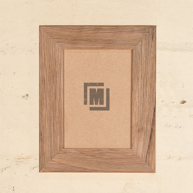 May include: A rustic wooden picture frame with a light brown finish. The frame has a simple design with a slightly raised edge around the opening. The frame is empty and ready to display a photo or artwork.