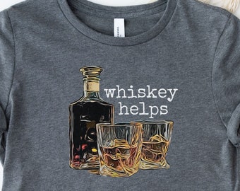 May include: A dark gray t-shirt with a graphic of a bottle and two glasses of whiskey. The text "whiskey helps" is printed in white on the shirt.