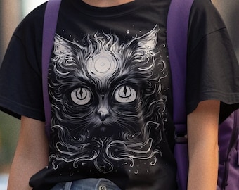 May include: A black t-shirt featuring a white graphic of a cat's face with a third eye in the centre of its forehead. The cat's face is surrounded by a swirling design.
