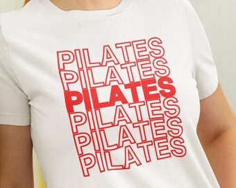 May include: White t-shirt with the word "PILATES" repeated five times in red, stacked vertically.