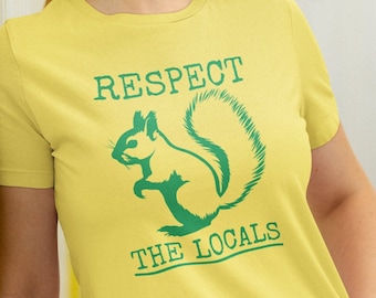 May include: Yellow t-shirt with a green squirrel graphic and the text "Respect the Locals".