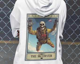 May include: White hoodie with a graphic of a skeleton skydiving with the text "The Skydiver" on the back.