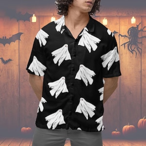 May include: A black button-up shirt with a short sleeve design featuring a white ghost pattern.