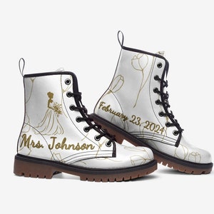 May include: White leather combat boots with a gold silhouette of a bride holding a bouquet, the text "Mrs. Johnson" and the date "February 23, 2024".