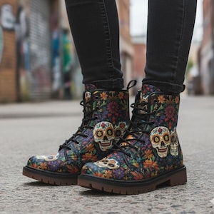 May include: Lace-up combat boots with a colourful floral and skull pattern. The boots have a brown sole and black laces. The design includes various flowers in shades of red, yellow, and orange, with multiple sugar skull designs.